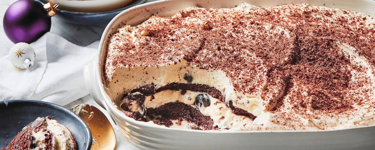 Amarenakirschen-Tiramisu angeschnitten in einer Auflaufform auf einem weihnachtlich dekorierten Tisch