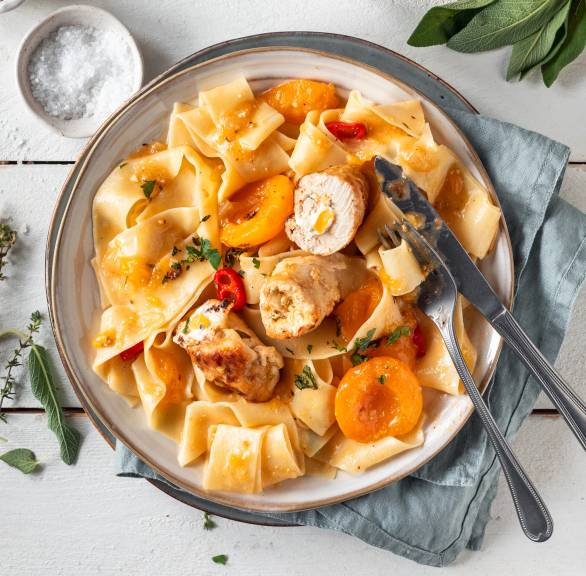 Hähnchen-Involtini mit Ricotta-Aprikosen-Füllung mit Pappardelle in Soße angerichtet auf einem Pastateller