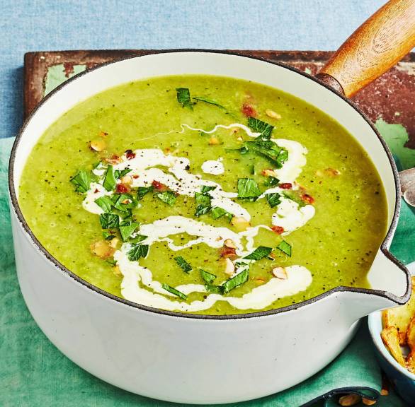 Kartoffel-Brokkolisuppe mit Crème fraîche- und Rauchmandel-Topping in einem Stieltopf auf einem Tisch