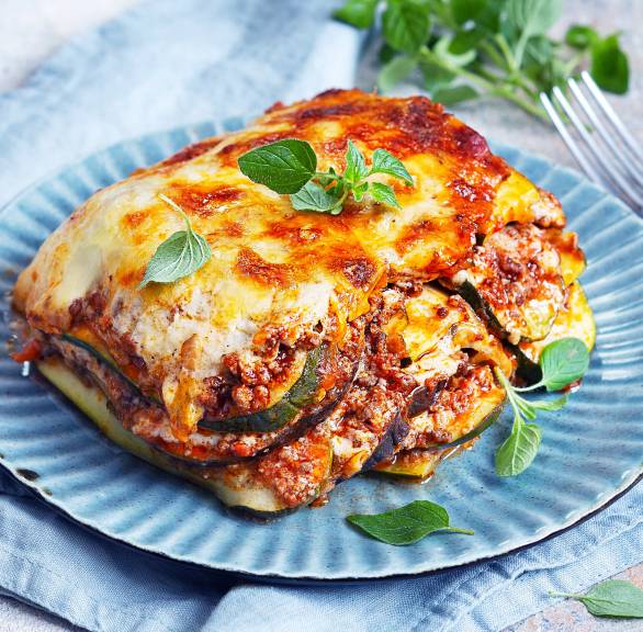 Ein Stück Low Carb-Zucchini-Lasagne angerichtet auf einem Teller