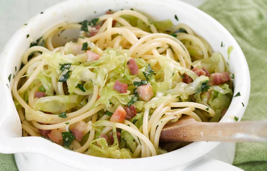 Spitzkohl-Spaghetti-Mischung in einer Schüssel mit Carbonara-Sauce