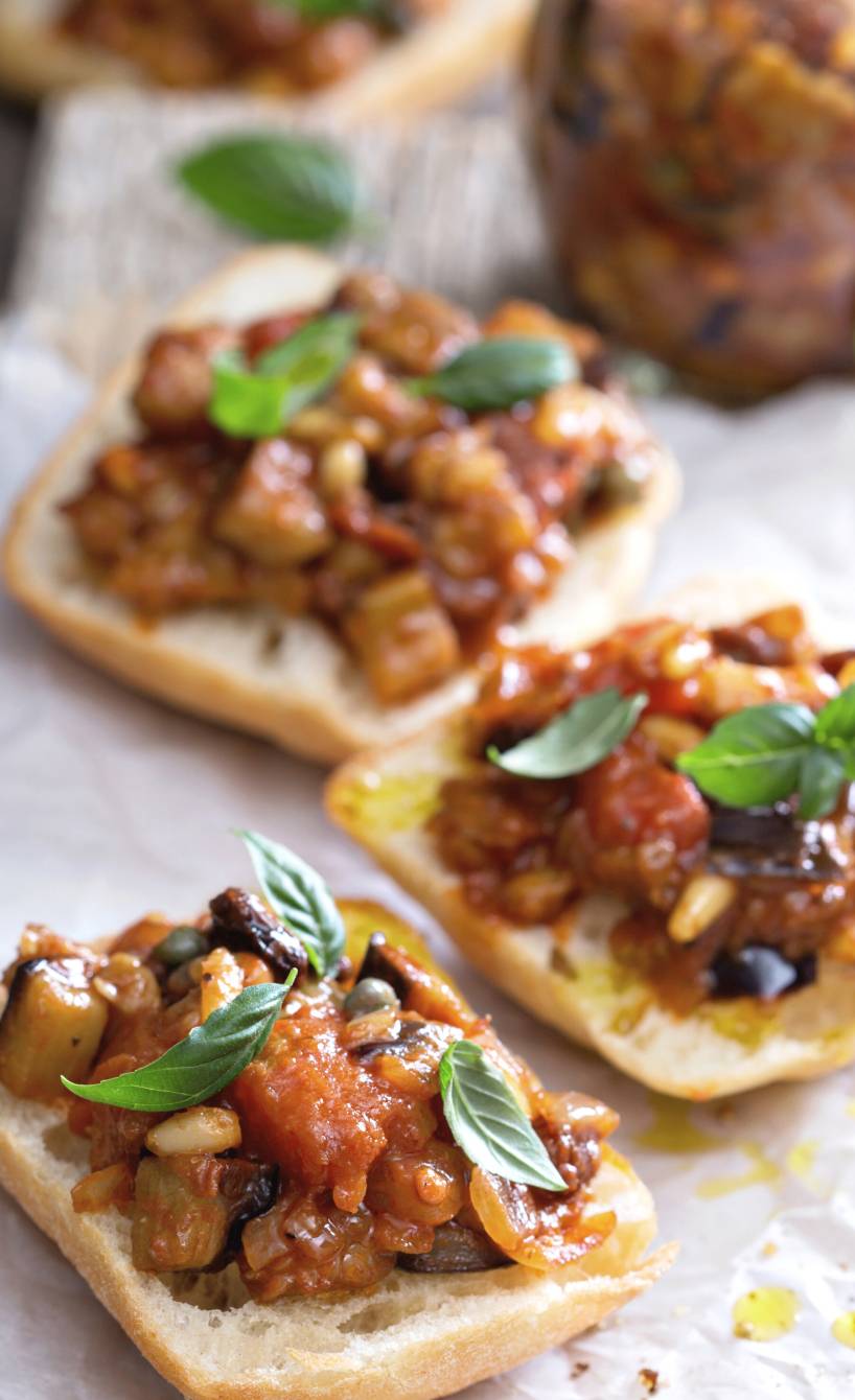 Caponata auf halbierten Ciabatta-Brötchen garniert mit frischem Basilikum