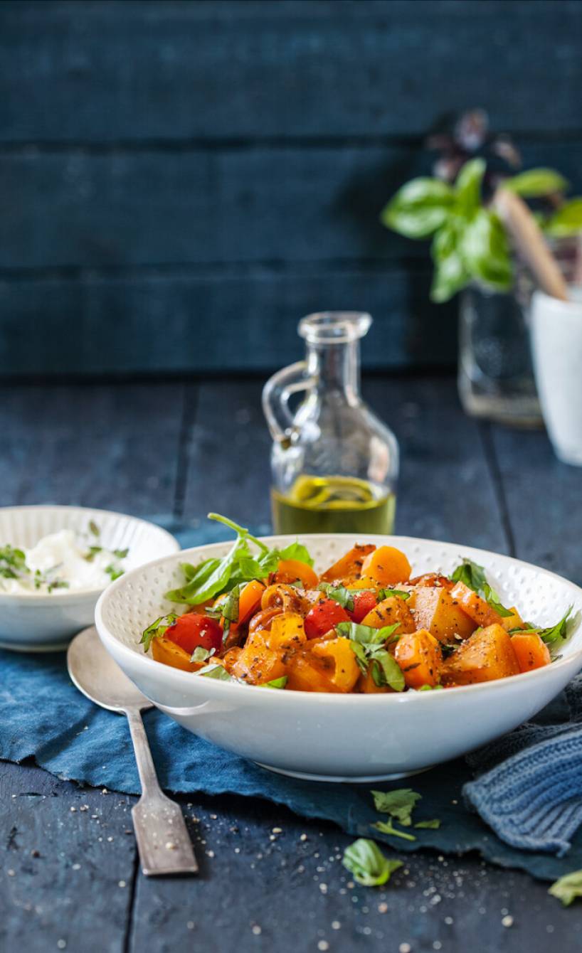 Kartoffelragout mit Gemüse und Mascarpone-Sauce angerichtet auf einem tiefen Teller