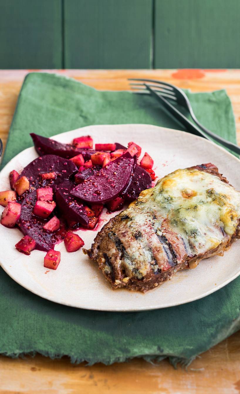 Mit Gorgonzola gratiniertes Rumpsteak angerichtet mit Apfel-Rote-Bete-Salat auf einem Teller