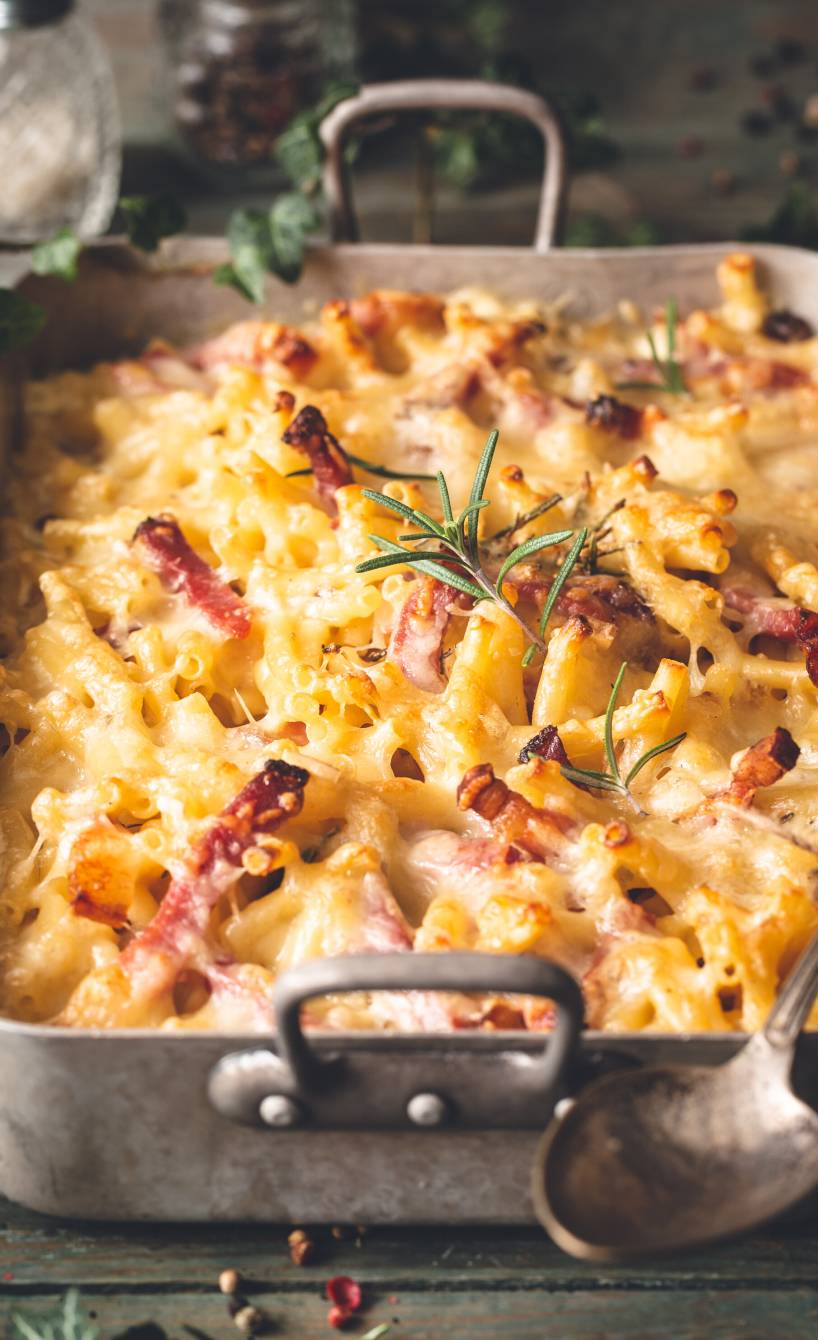 Spitzkohlauflauf mit Maccheroni und Schinkenwürfeln in einer Auflaufform auf einem Tisch