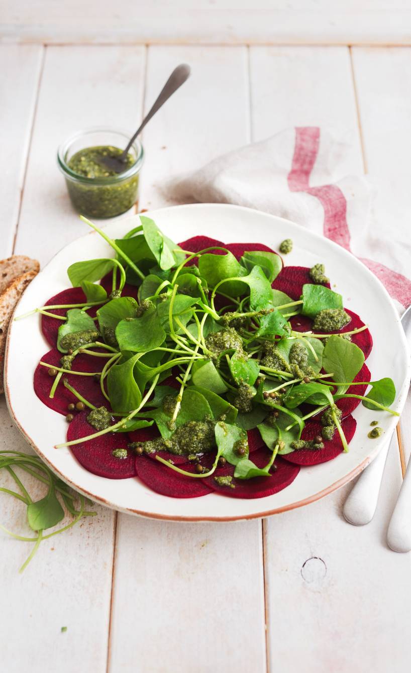Rote-Bete-Salat auf einem Teller getoppt von mit Portulak und Kürbiskernpesto