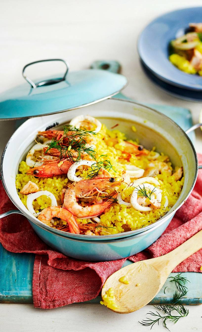 Safranrisotto mit Meeresfrüchten in einem Kochtopf auf einem Tisch