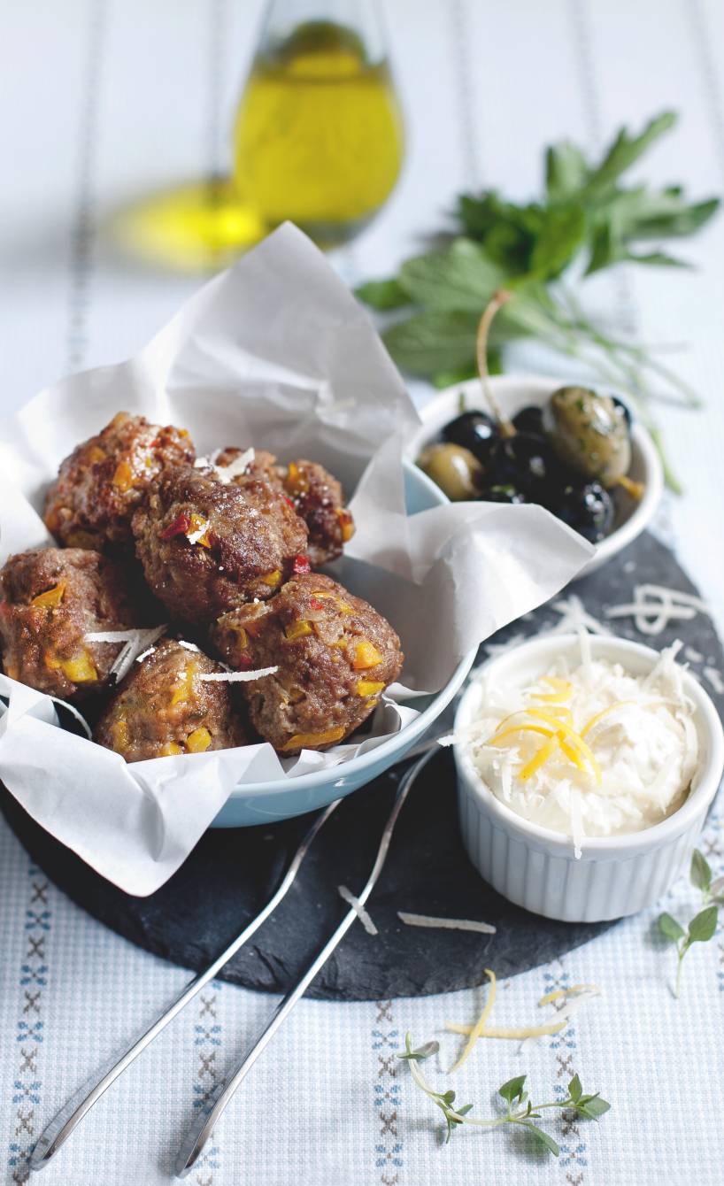 Mini-Frikadellen in einer Schüssel, daneben eine Schale mit Parmesancreme