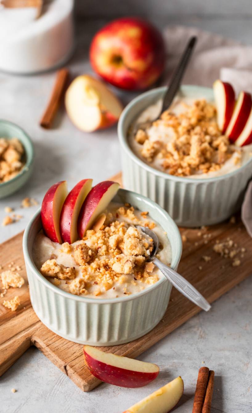 Selbstgekochtes Grießbrei in zwei Dessertschälchen getoppt mit Streuseln und Apfelspalten