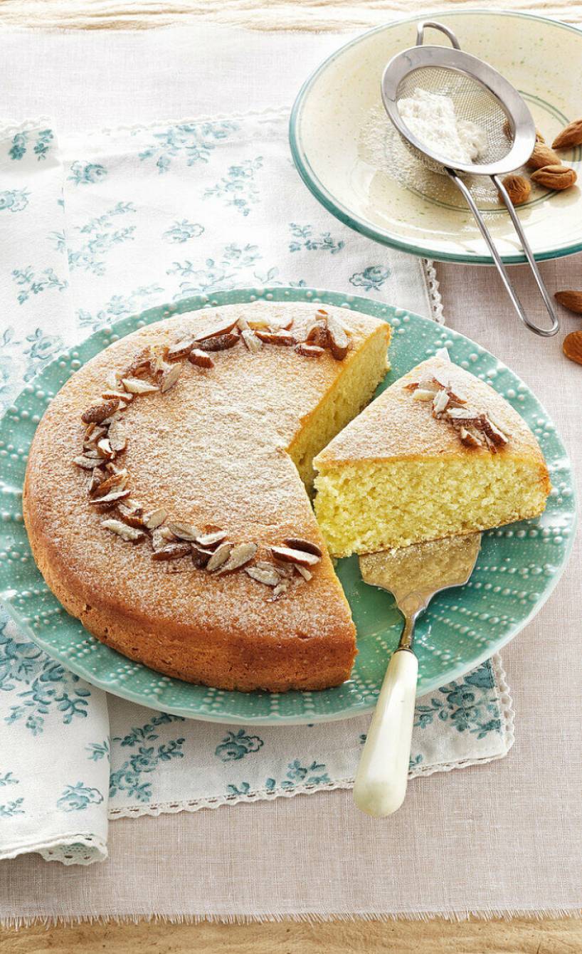 Runder sizilianischer Mandelkuchen angeschnitten auf einer Tortenplatte
