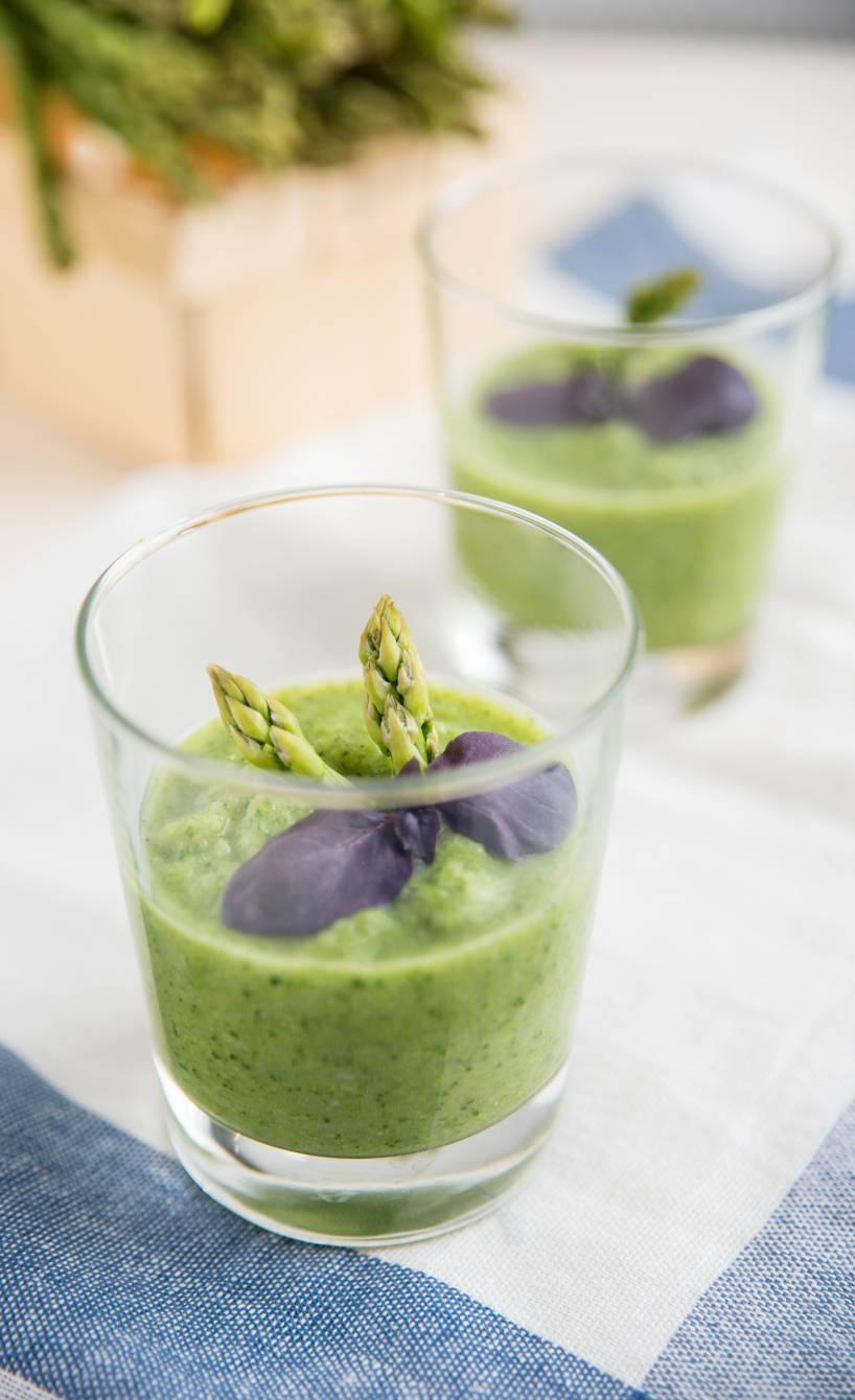 Zwei Gläser Detox-Smoothie mit Spinat, Honigmelone und Spargel auf einem Tisch